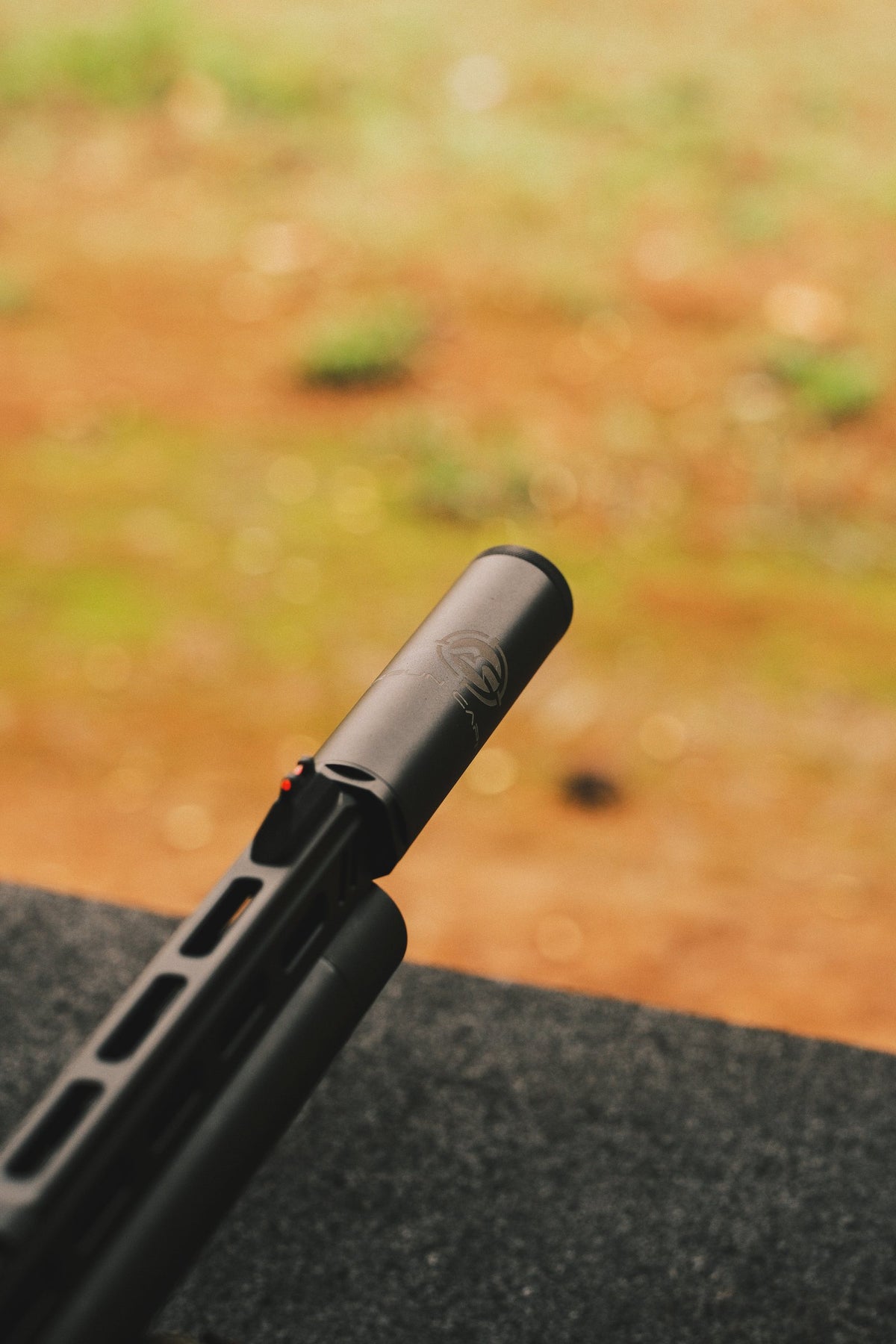 Airgun Capital suppressor on an air pistol, angled toward the range